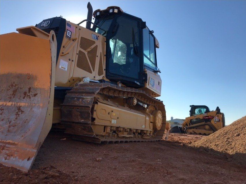CAT dozer and skid steer staged on a Mesa job site