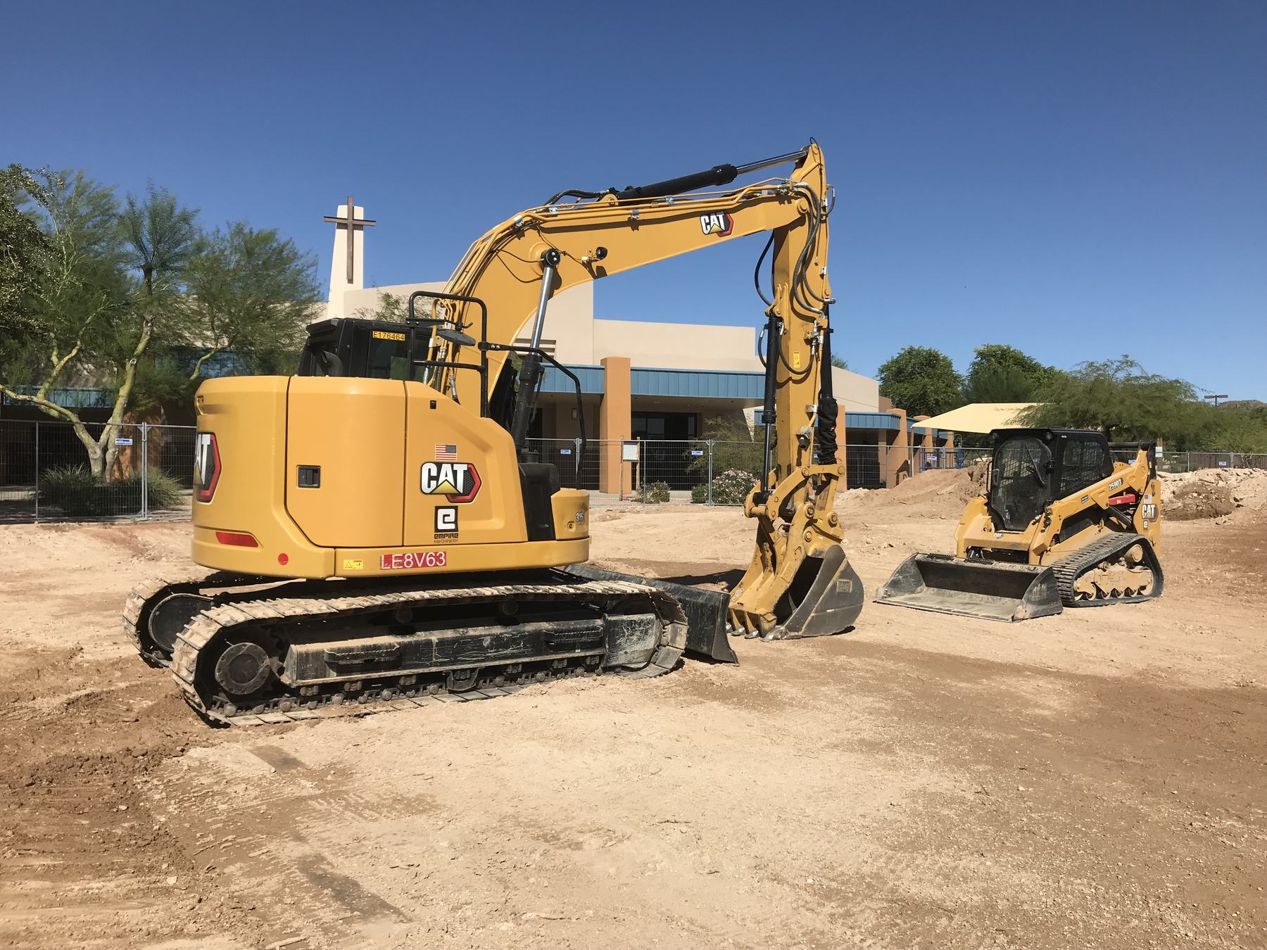 CAT excavator and skid steer staged on a Mesa job site